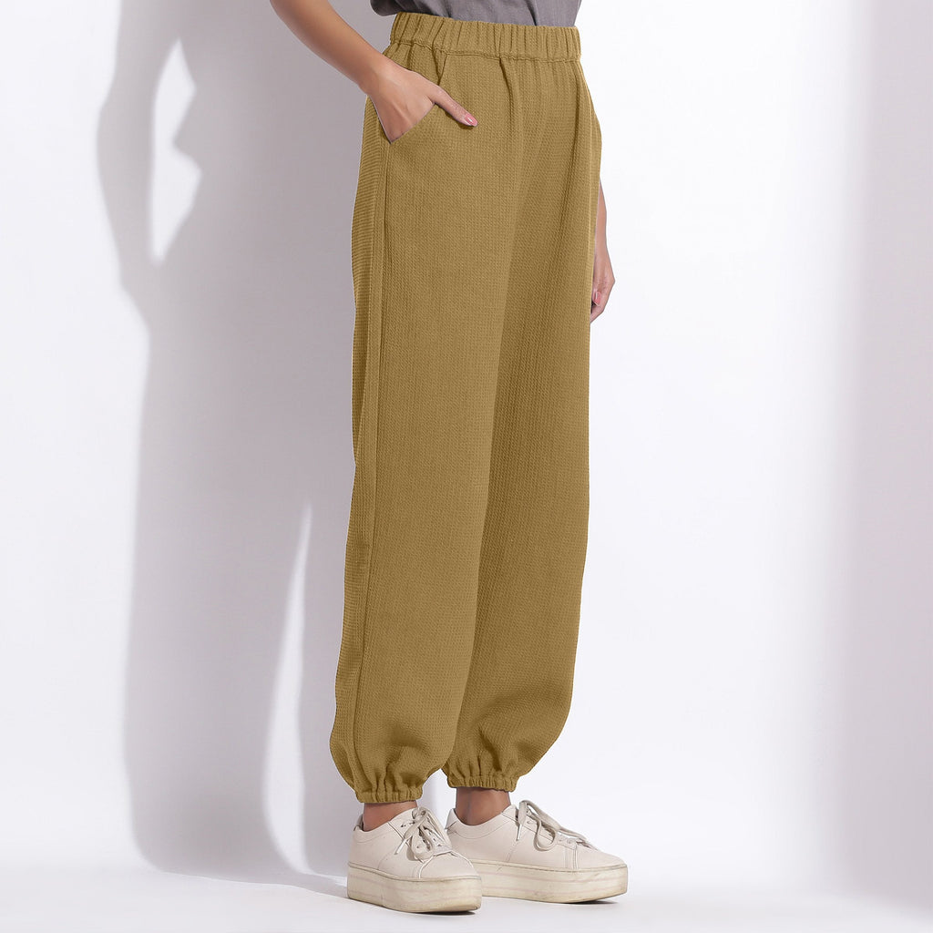 Right View of a Model wearing Comfy Olive Green Cotton Waffle Jogger Pants