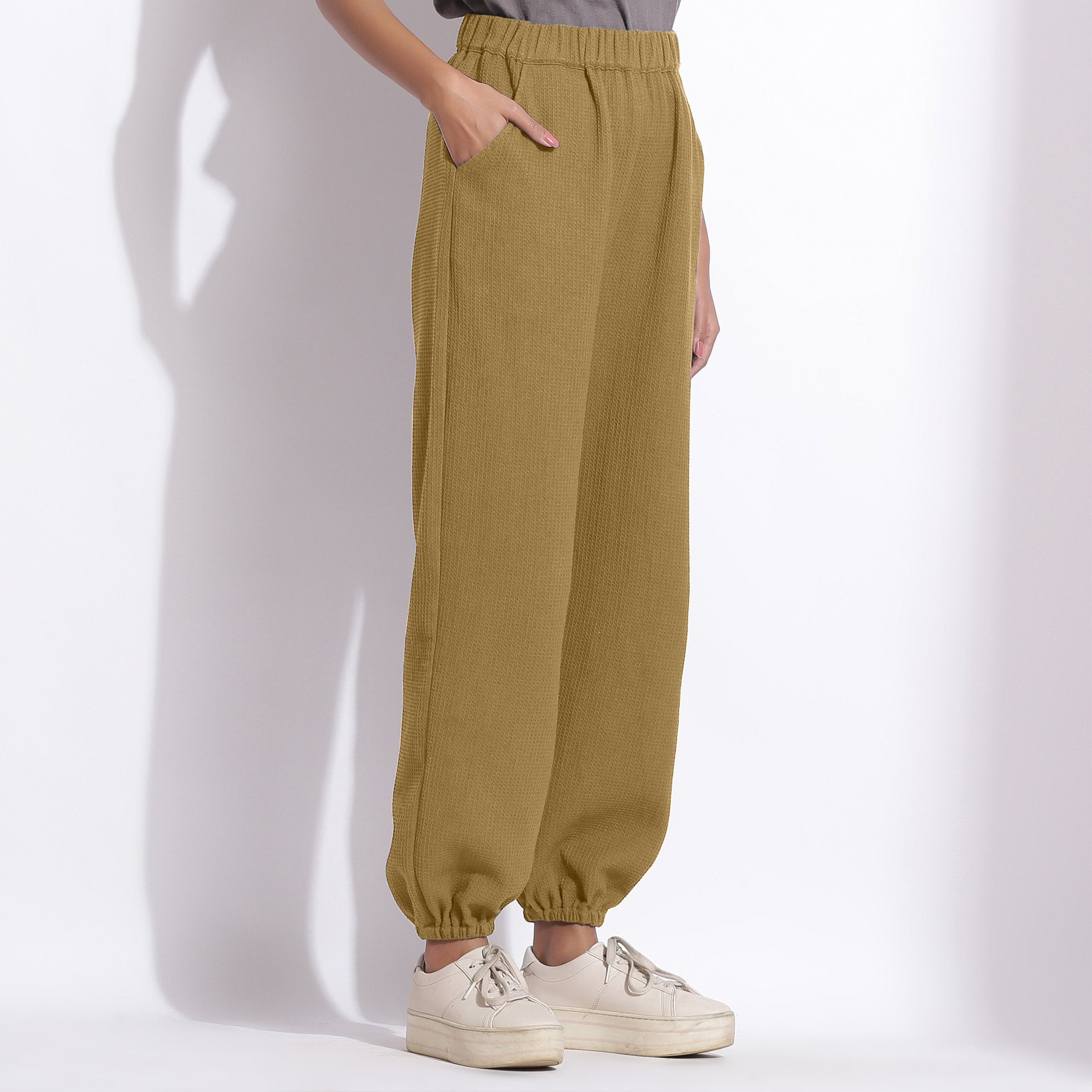 Right View of a Model wearing Comfy Olive Green Cotton Waffle Jogger Pants