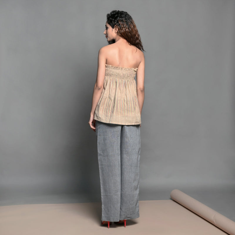 Back View of a Model wearing Convertible Beige Handwoven Cotton Elasticated Shirred Top Skirt