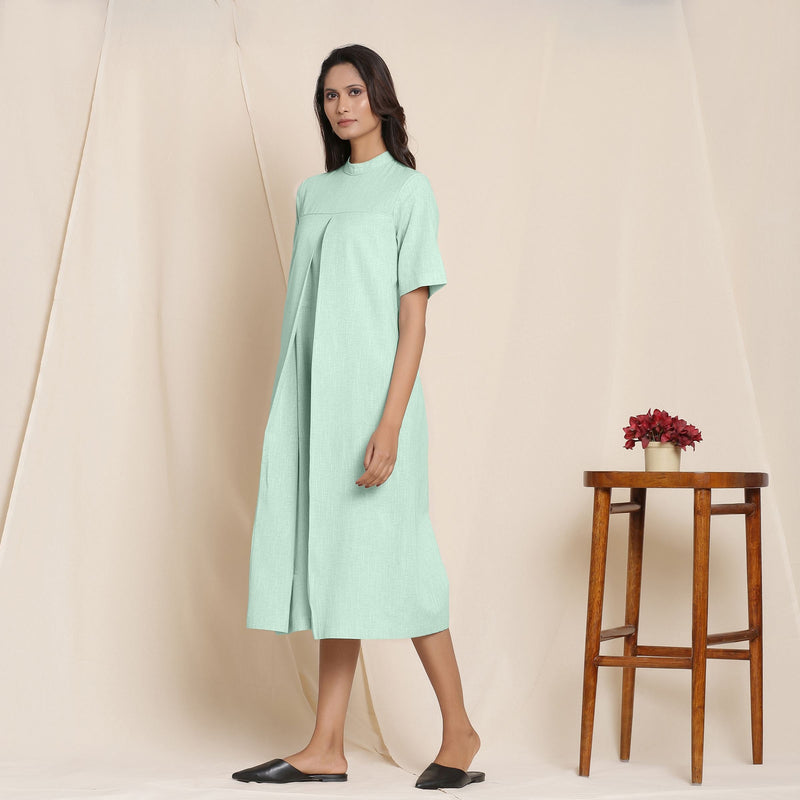 Left View of a Model wearing Cotton Aqua Box Pleated Jumpsuit