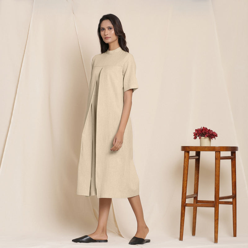 Left View of a Model wearing Cotton Beige Box Pleated Jumpsuit