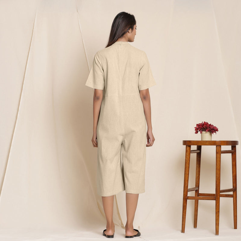 Back View of a Model wearing Cotton Beige Box Pleated Jumpsuit