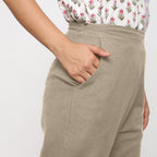 Right Detail of a Model wearing Cotton Flax Mid-Rise Beige Tapered Pant