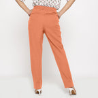 Back View of a Model wearing Cotton Flax Mid-Rise Peach Tapered Pant