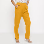 Right View of a Model wearing Cotton Flax Mid-Rise Yellow Tapered Pant
