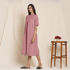 Left View of a Model wearing Cotton Maroon Box Pleated Jumpsuit