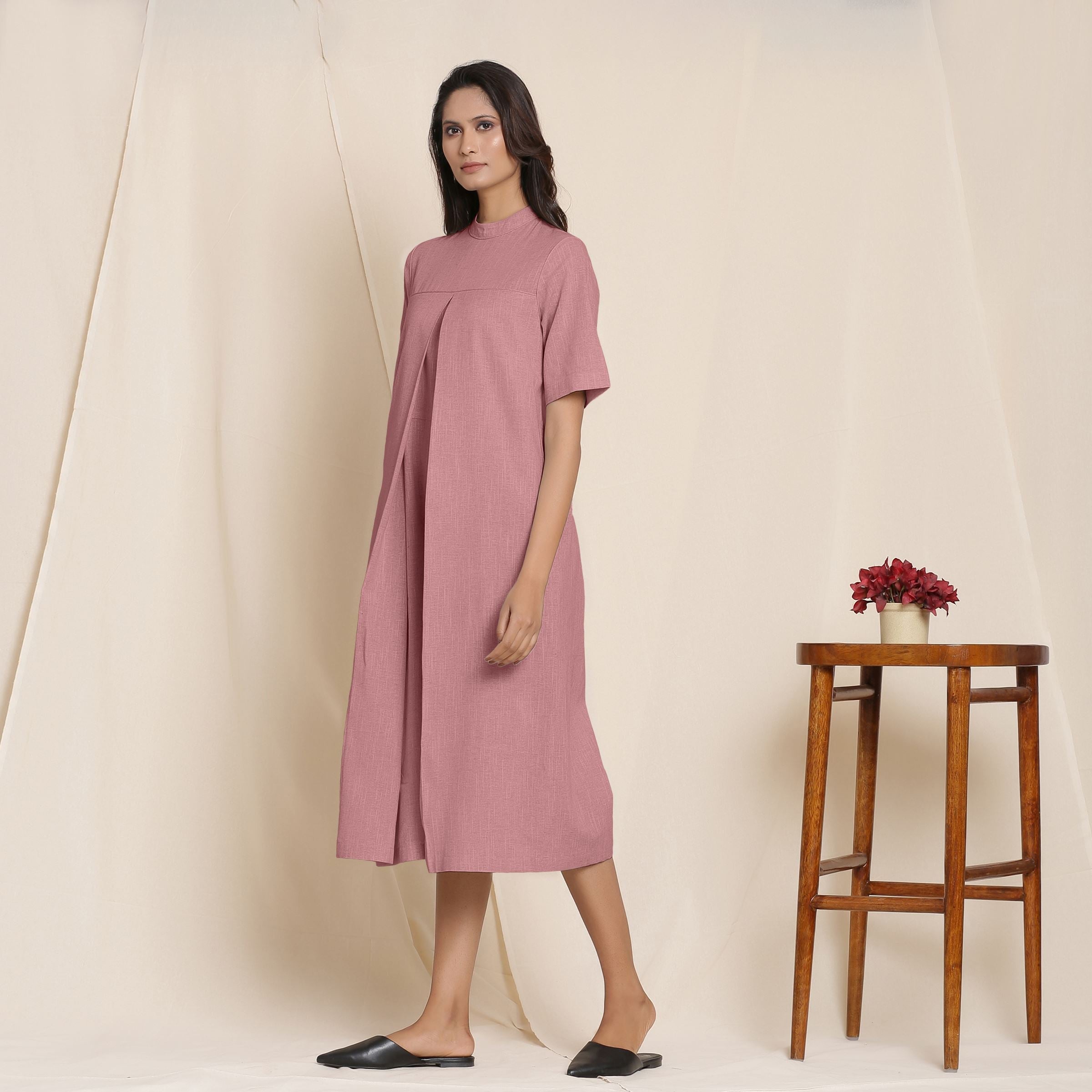 Left View of a Model wearing Cotton Maroon Box Pleated Jumpsuit