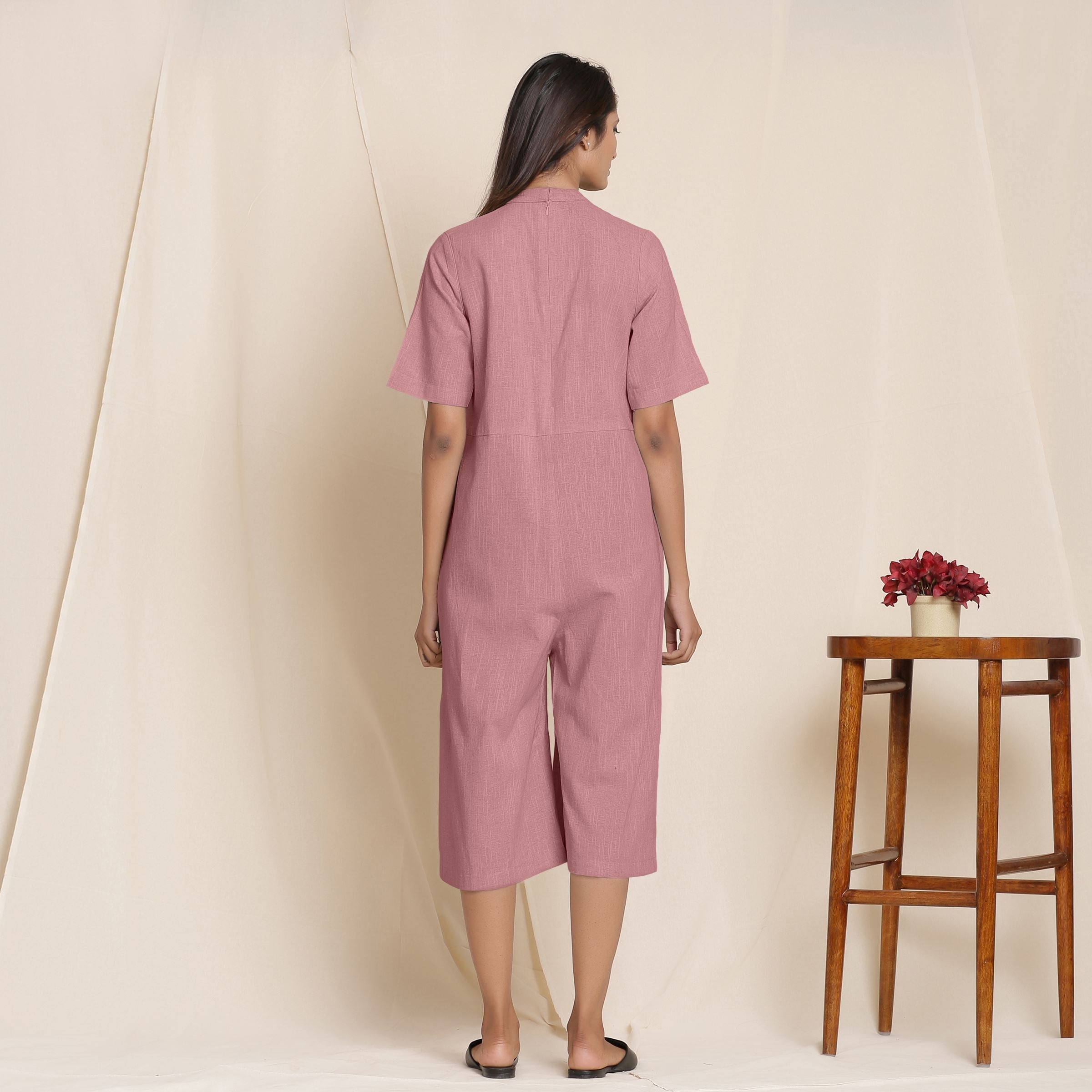 Back View of a Model wearing Cotton Maroon Box Pleated Jumpsuit