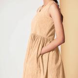 Left Detail of a Model wearing Cotton Peach Mellow Gathered Yoke Dress