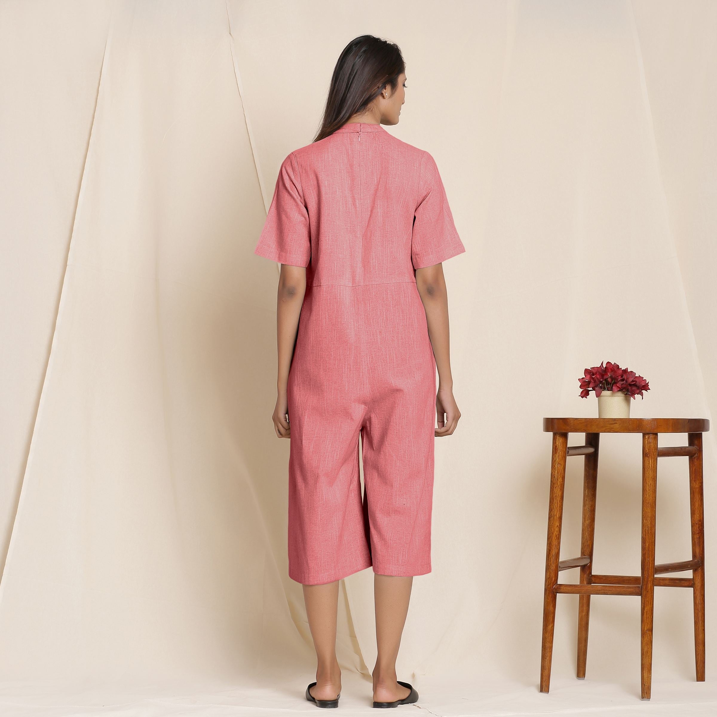 Back View of a Model wearing Cotton Red Box Pleated Jumpsuit