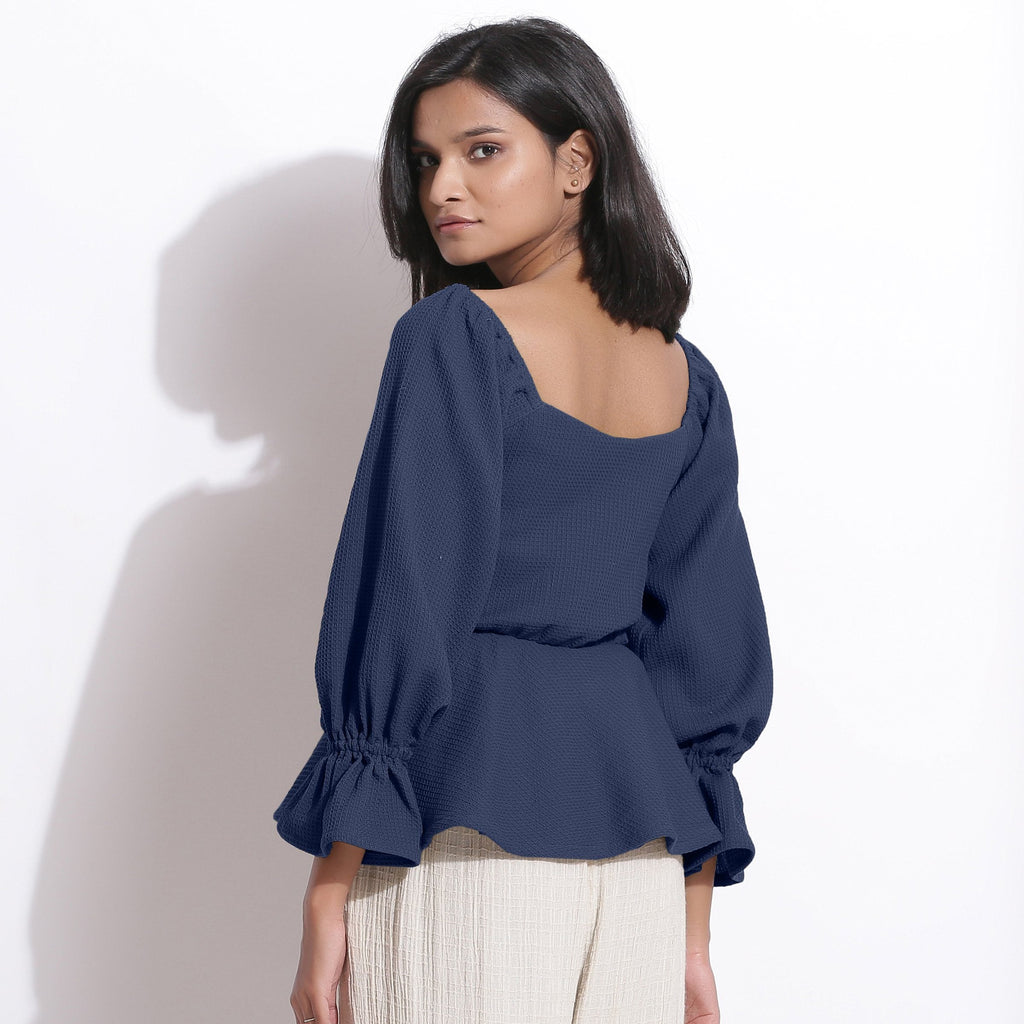 Back View of a Model wearing Cotton Waffle Navy Blue Peplum Top