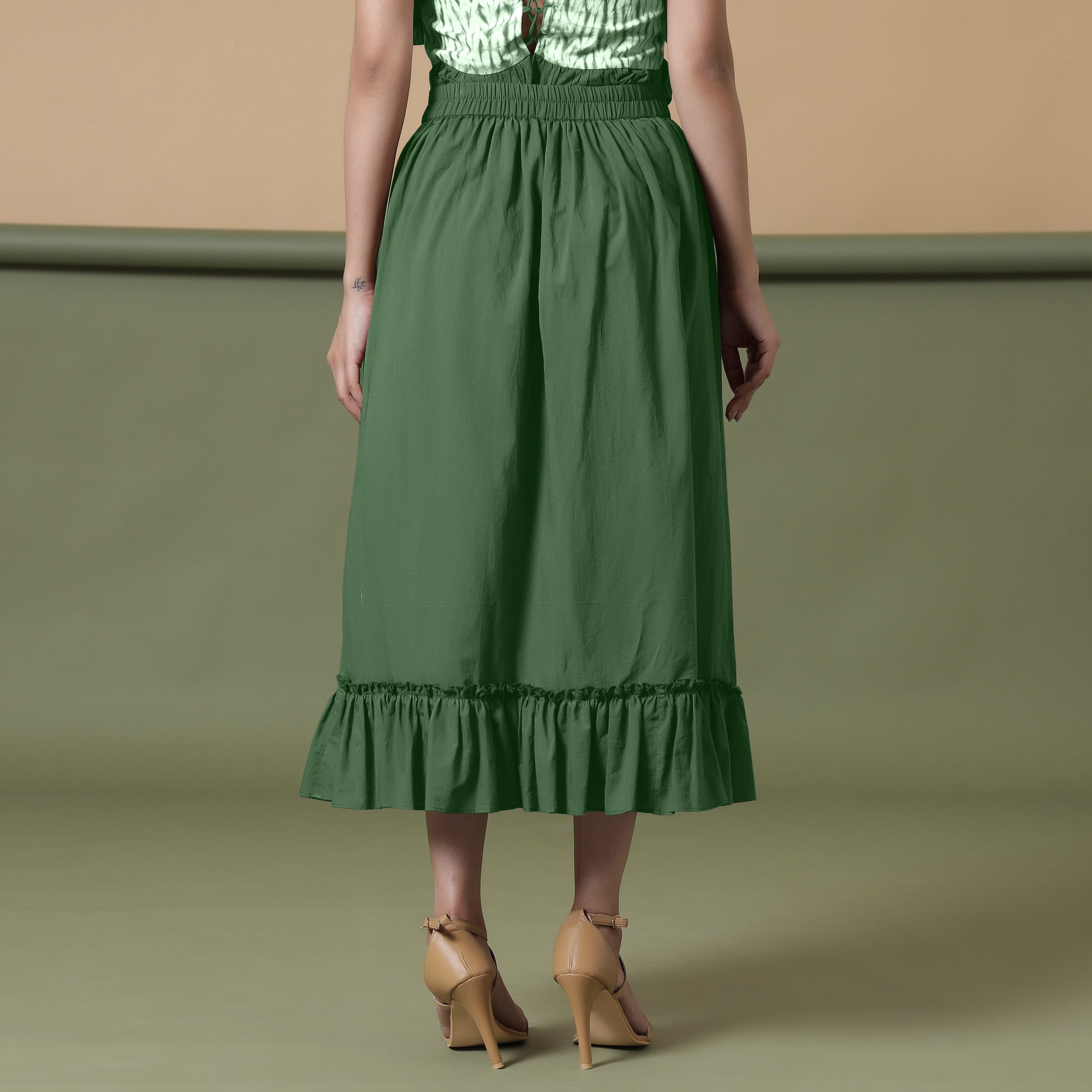 Back View of a Model wearing Dark Green A-Line Ruffled Cotton Skirt