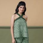 Front View of a Model wearing Dark Green Shibori Halter Neck Flared Top