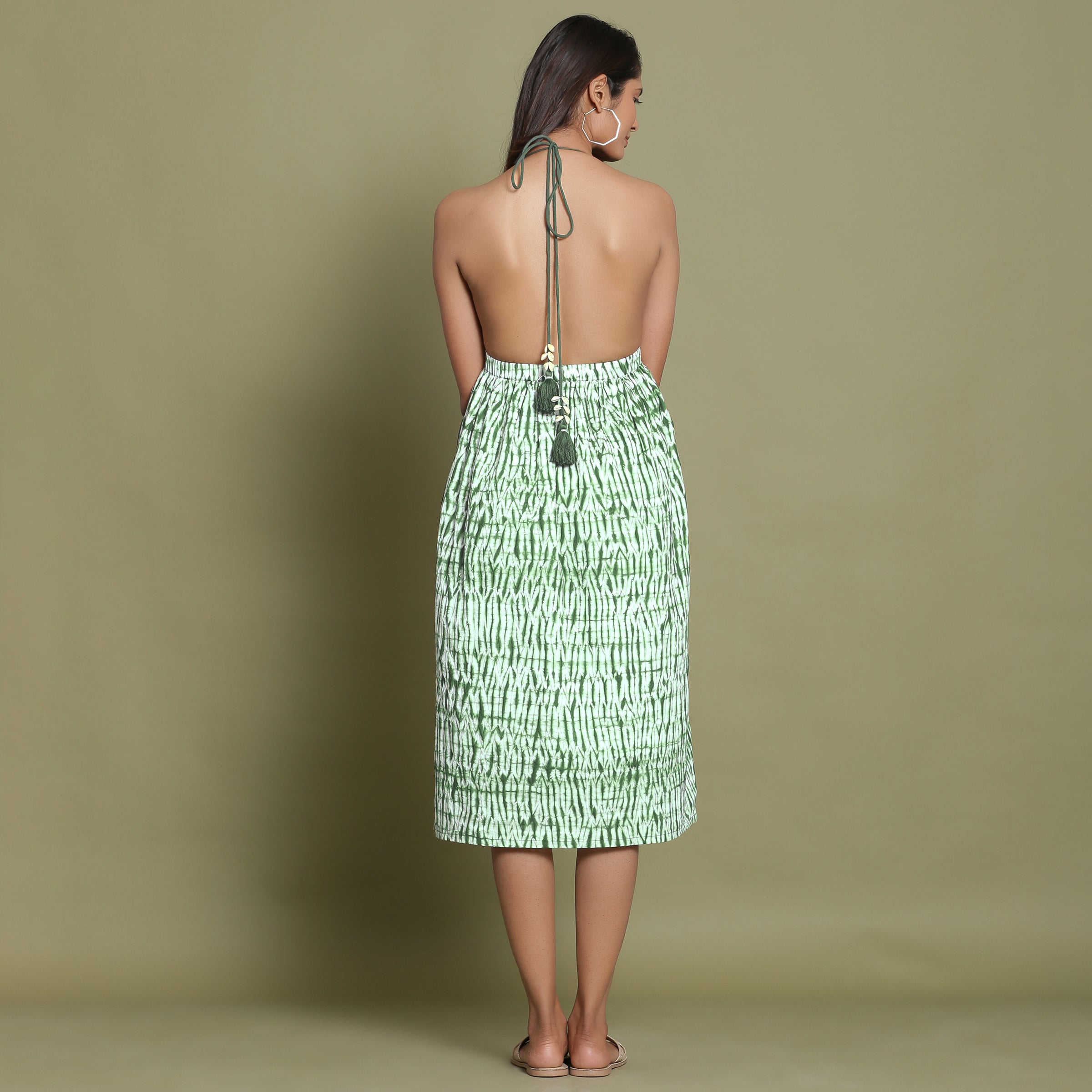 Back View of a Model wearing Dark Green Shibori Halter Neck Gathered Dress