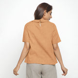 Back View of a Model wearing Desert Yellow 100% Linen Peter Pan Collar Top