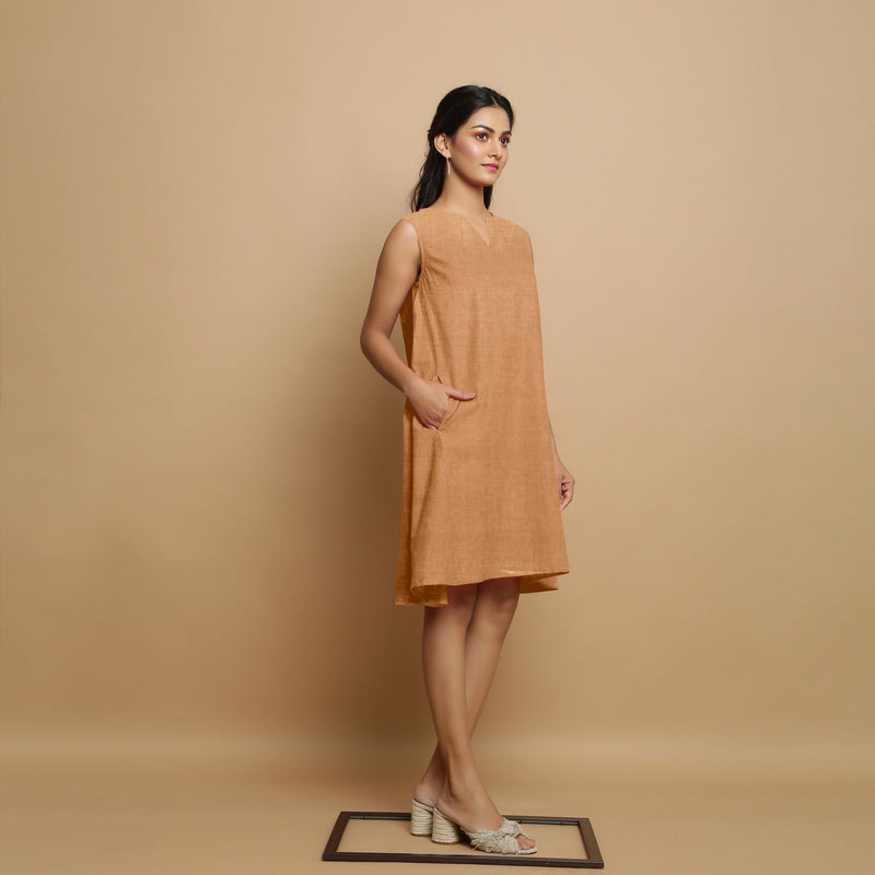 Right View of a Model wearing Desert Yellow Linen Embroidered Knee-Length Godet Dress