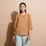 Front View of a Model wearing Desert Yellow 100% Linen Split-Neck Tunic Top