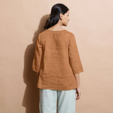 Back View of a Model wearing Desert Yellow 100% Linen Split-Neck Tunic Top