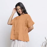 Left View of a Model wearing Desert Yellow Round Neck Linen Yoked Top