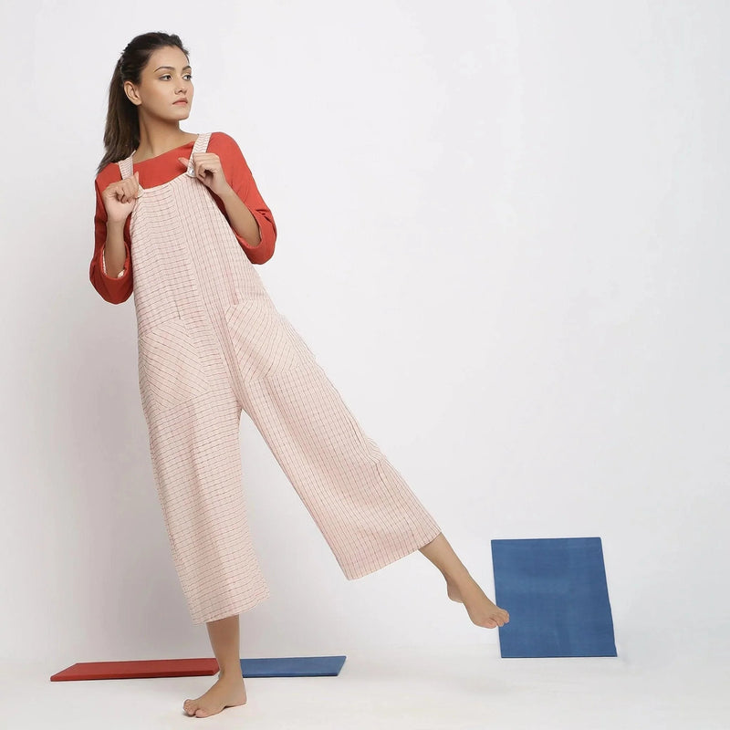 Front View of a Model wearing Ecru and Brick Red Striped Vegetable Dyed Cotton Pinafore Jumpsuit