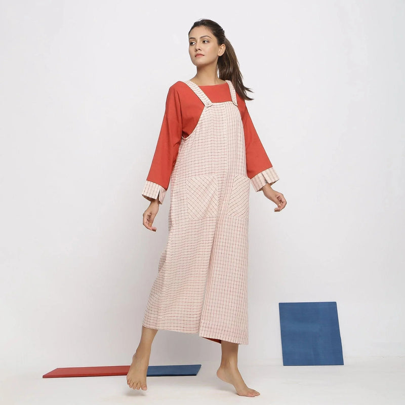 Right View of a Model wearing Ecru and Brick Red Striped Vegetable Dyed Cotton Pinafore Jumpsuit