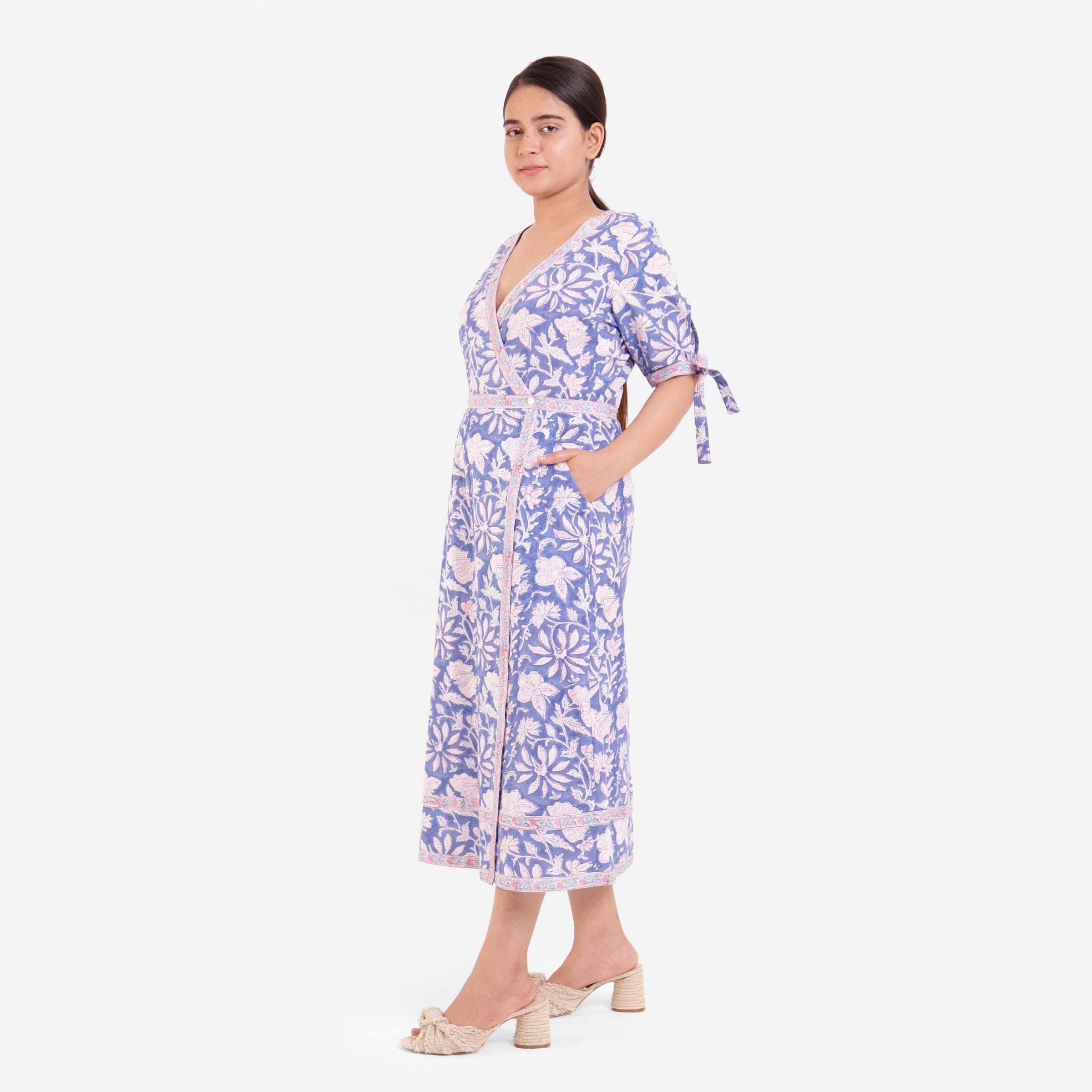 Left View of a Model wearing Blue Plunge Neck Floral Wrap Dress