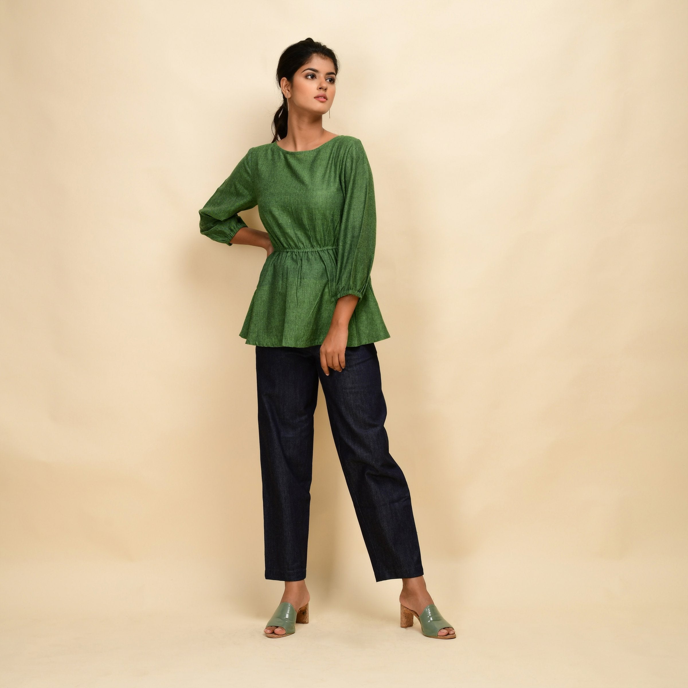 Front View of a Model wearing Forest Green Yarn Dyed Cotton Round Neck Peplum Top