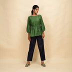 Front View of a Model wearing Forest Green Yarn Dyed Cotton Round Neck Peplum Top