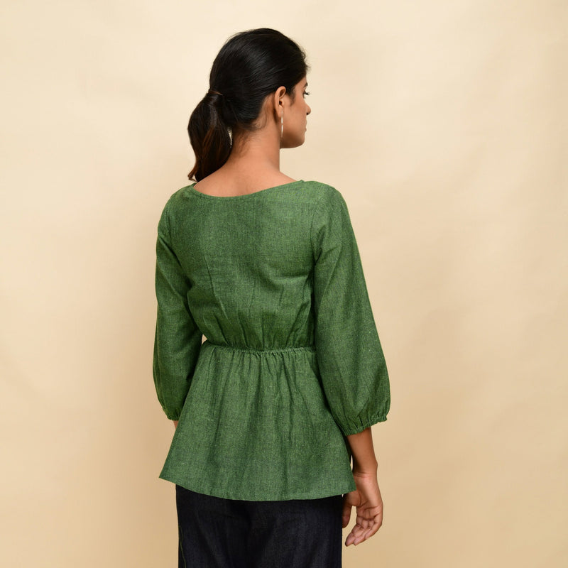 Back View of a Model wearing Forest Green Yarn Dyed Cotton Round Neck Peplum Top