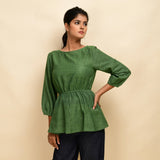 Front View of a Model wearing Forest Green Yarn Dyed Cotton Round Neck Peplum Top