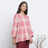 Right View of a Model wearing Fuchsia and Pink Checkered Flared Top