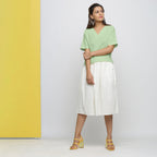 Front View of a Model wearing Green Yarn Dyed 100% Cotton V-Neck High-Low Top
