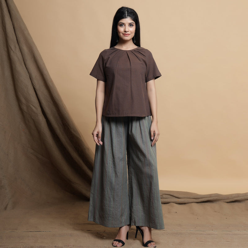 Front View of a Model wearing Grey Striped Wide Legged Pleated Pant