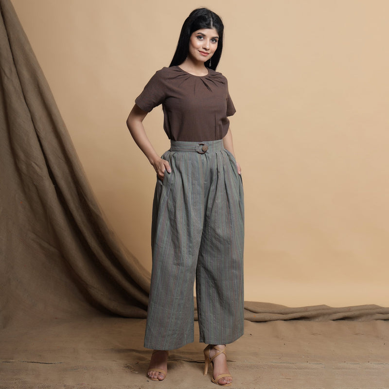 Right View of a Model wearing Grey Striped Wide Legged Pleated Pant