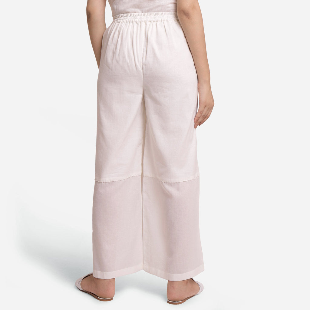 Back View of a Model wearing Off-White Hand Beaded Cotton Elasticated Wide Legged Pant