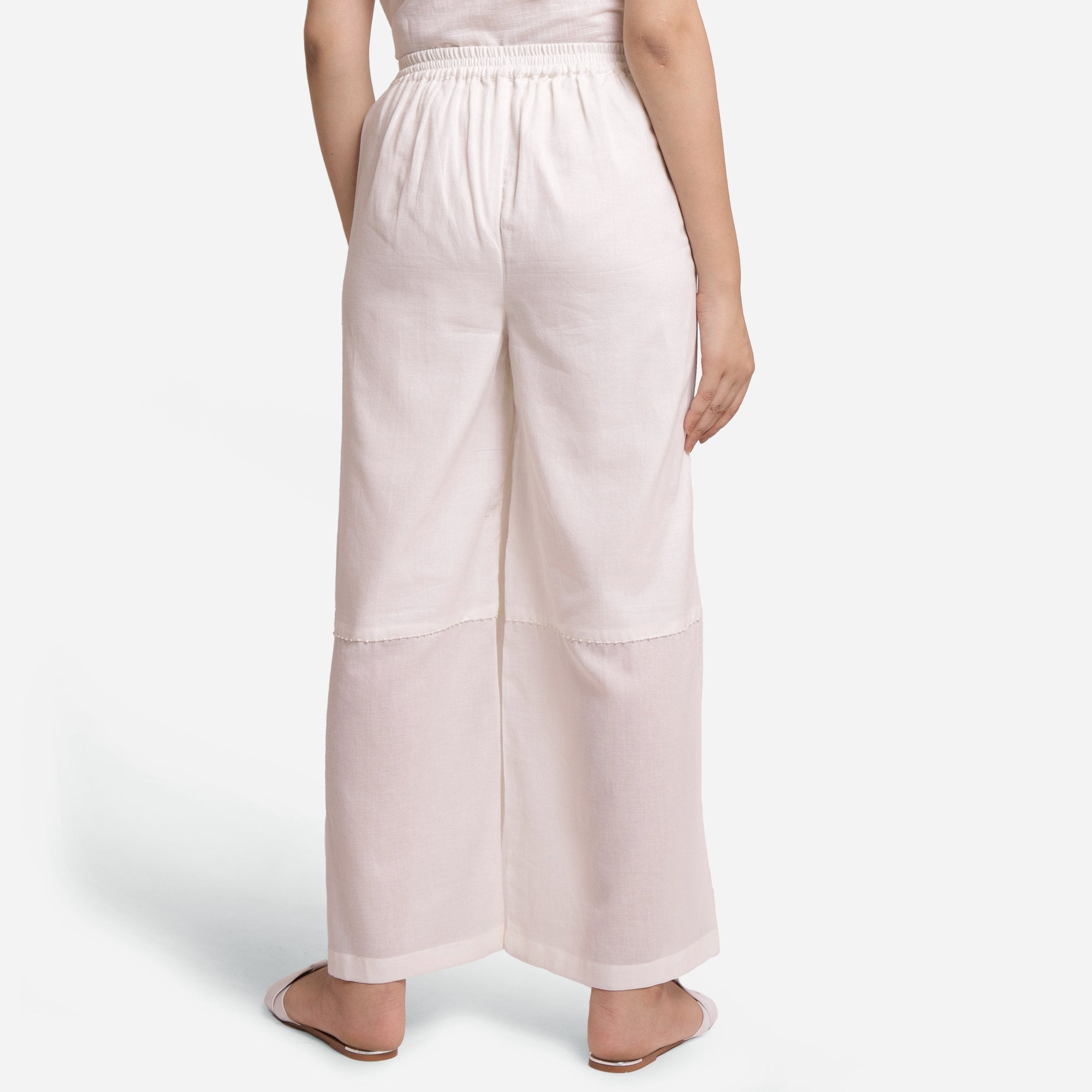 Back View of a Model wearing Off-White Hand Beaded Cotton Elasticated Wide Legged Pant