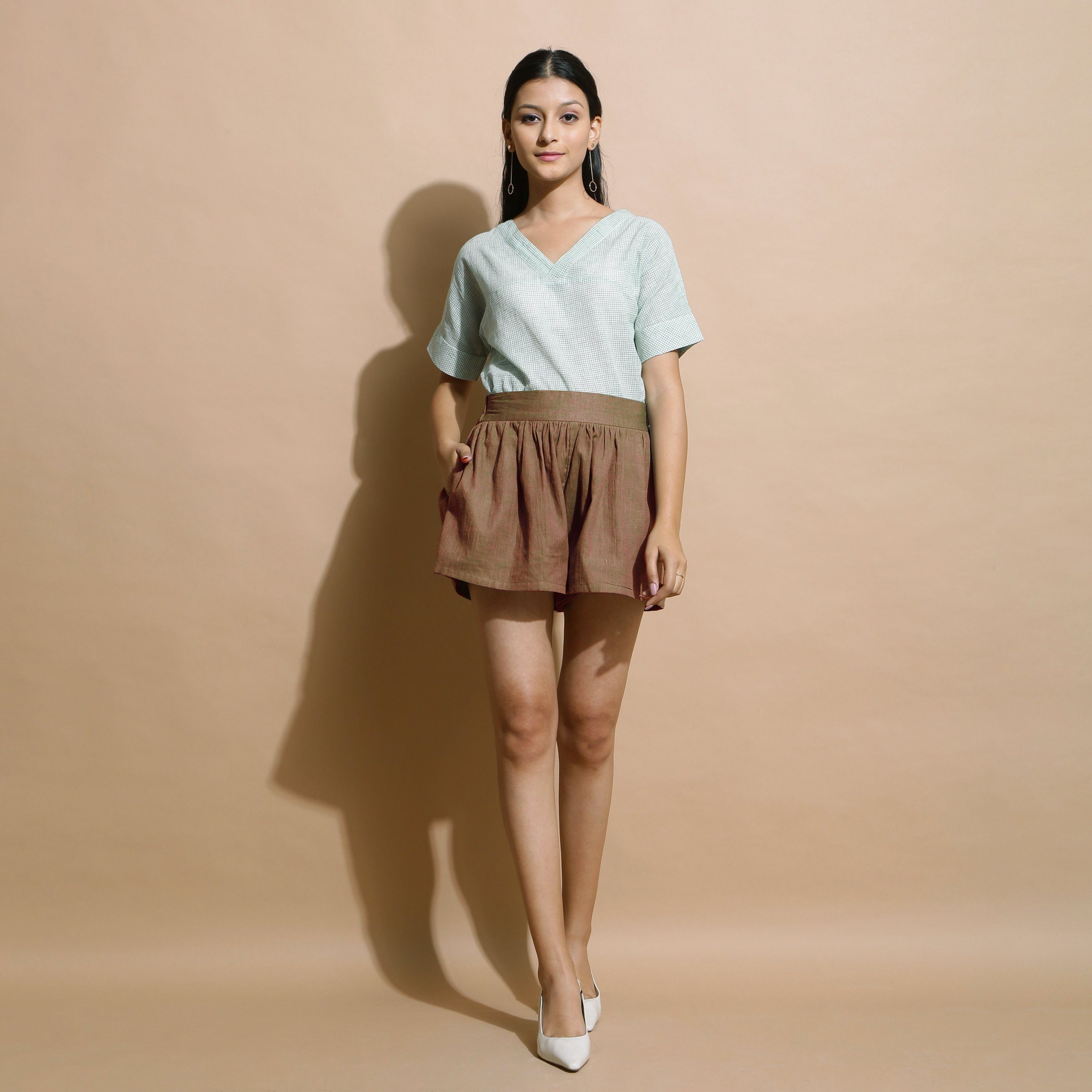 Front View of a Model wearing Handspun Brown Flared Shorts