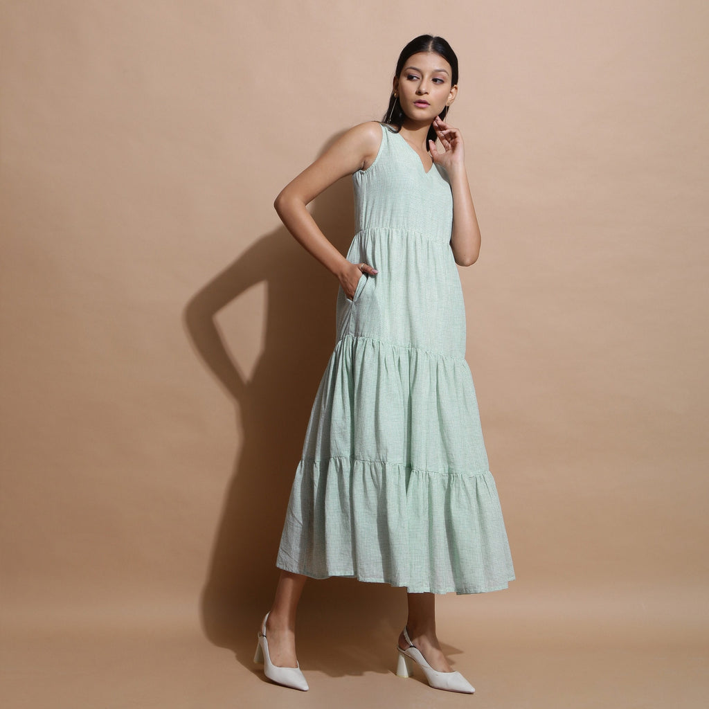 Right View of a Model wearing Light Green Cotton Muslin Checkered Maxi Tier Dress
