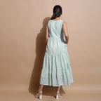 Back View of a Model wearing Light Green Cotton Muslin Checkered Maxi Tier Dress