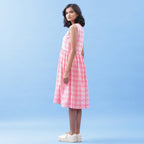 Left View of a Model wearing Pink Yarn Dyed Handspun Cotton V-Neck Yoked Midi Dress