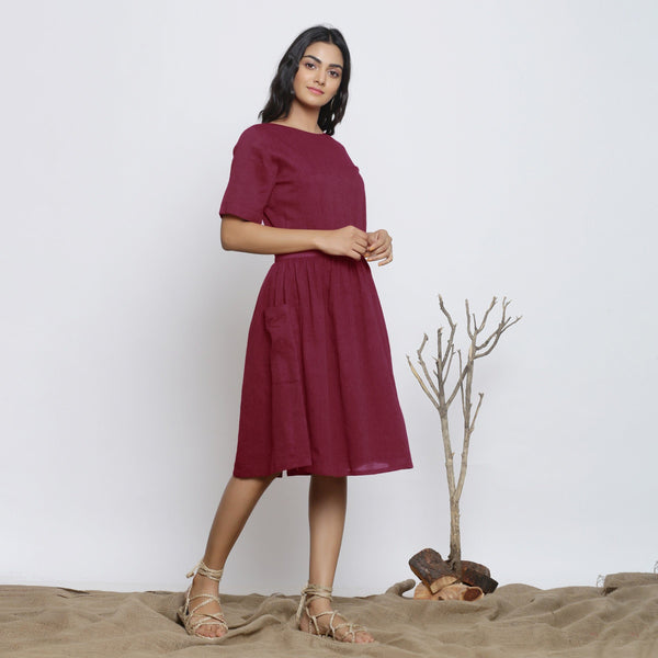 Right View of a Model wearing Handspun Maroon Backless Fit and Flare Dress