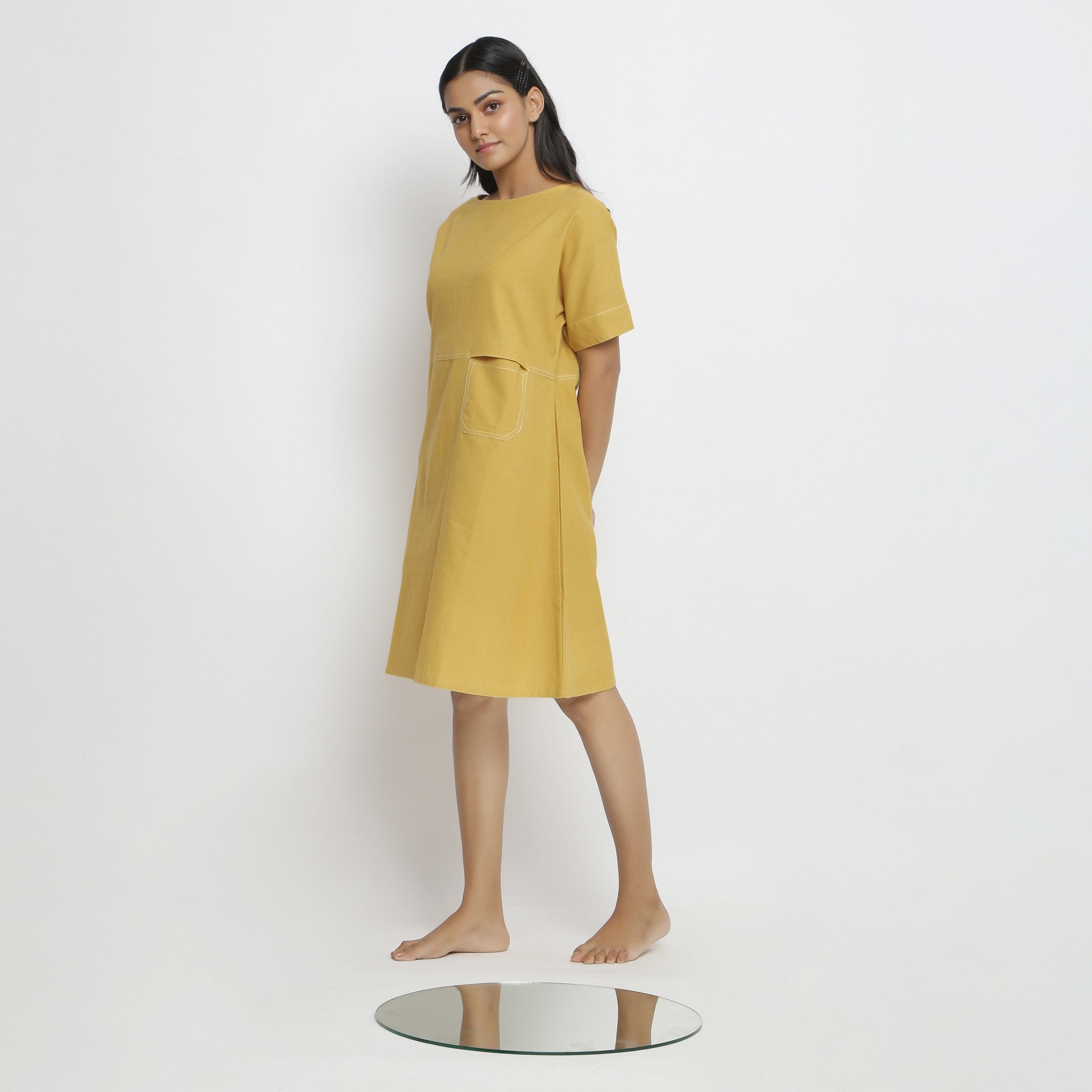Left View of a Model wearing Lemon Yellow Vegetable Dyed Handspun Cotton Knee Length Yoked Dress