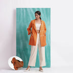 Front View of a Model wearing Handwoven Orange Welt Pocket Coat