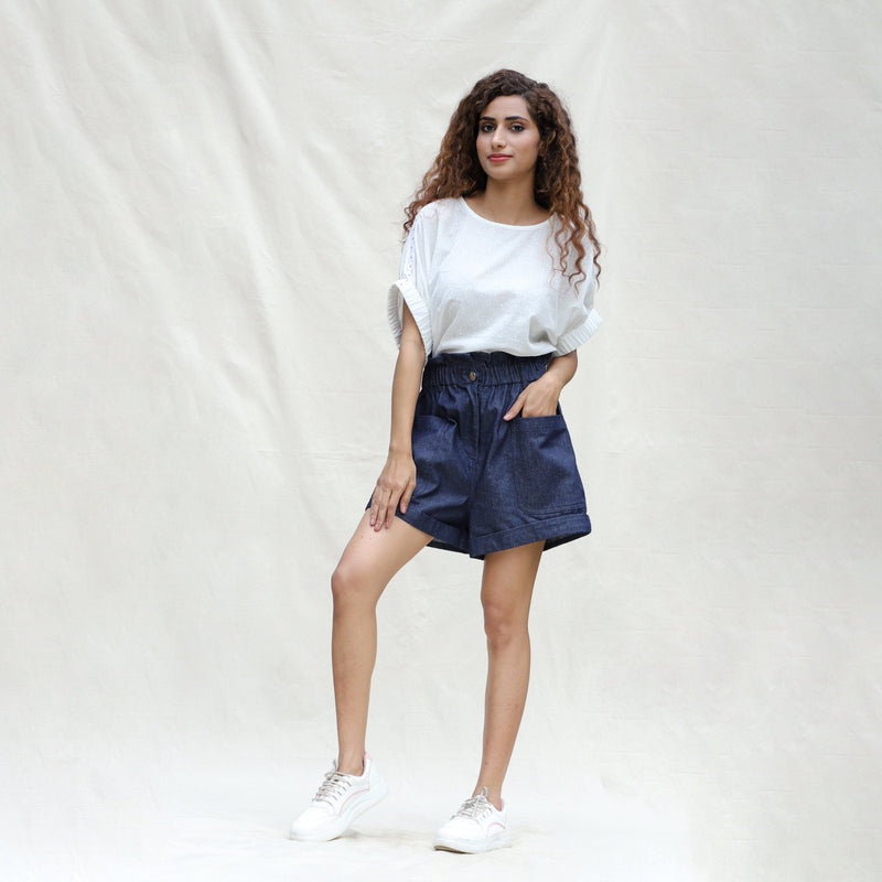 Front View of a Model wearing Indigo Cotton Denim High-Rise Paperbag Elasticated Shorts