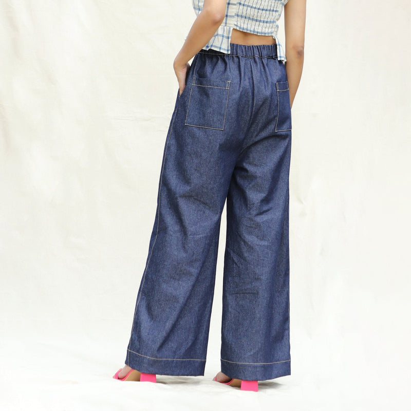 Back View of a Model wearing Indigo Cotton Denim High-Rise Elasticated Wide Legged Pant