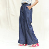 Left View of a Model wearing Indigo Cotton Denim High-Rise Elasticated Wide Legged Pant
