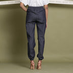Back View of a Model wearing Indigo Cotton Denim Elasticated Mid-Rise Jogger Pant