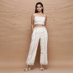 Front View of a Model wearing Ecru Jute Laced Cotton Muslin Mid-Rise Elasticated Pant