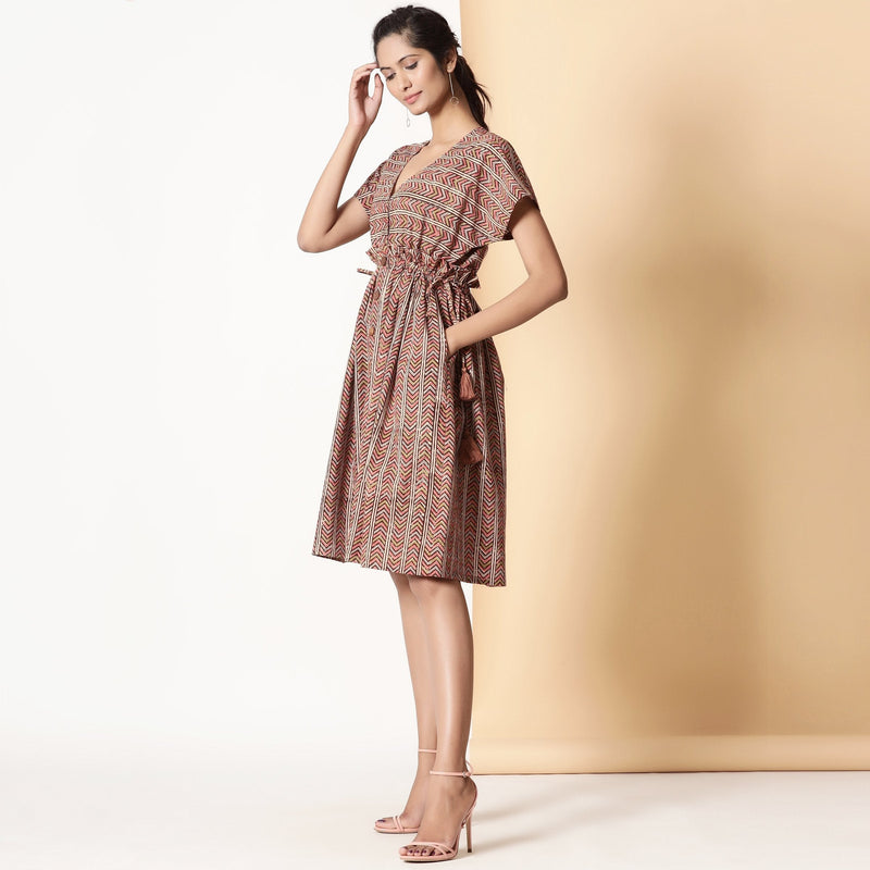 Left View of a Model wearing Kalamkari Block Printed Cotton Knee Length Frilled Dress
