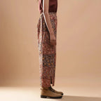 Right View of a Model wearing Muddy Red Wide-Leg Kalamkari Slit Pant